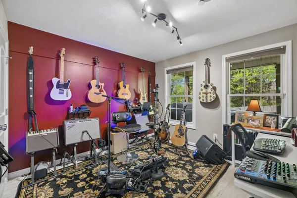 a room with lots of furniture and musical instruments