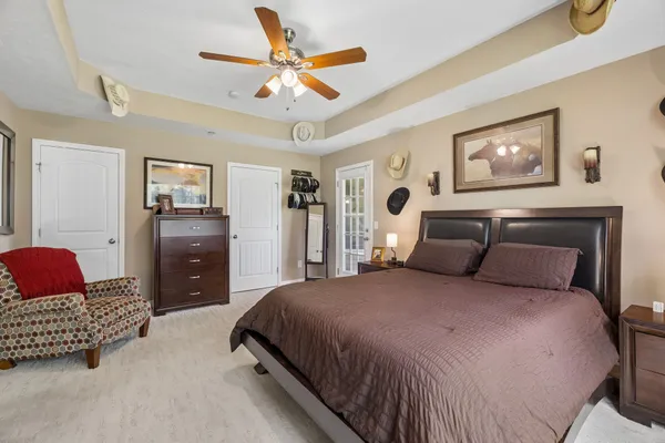a bedroom with a bed and a chandelier