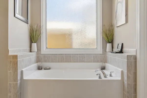 a spacious bathroom with a tub and a shower