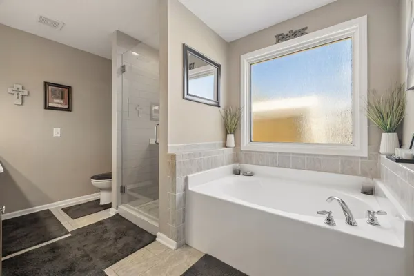 a bathroom with a sink a light fixture and a mirror