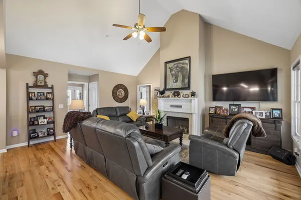a living room with furniture a flat screen tv and a fireplace