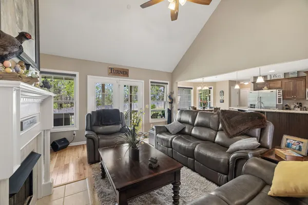 a view of a dining room with furniture large windows and wooden floor