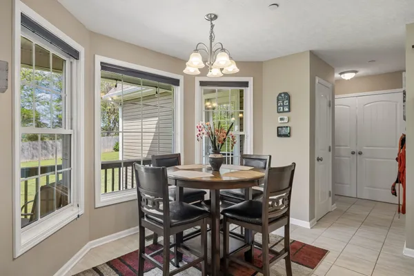 a dining room with furniture window and outside view