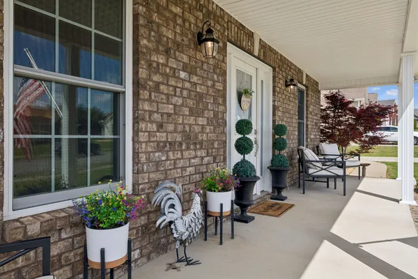 a view of a porch with chairs and potted plant