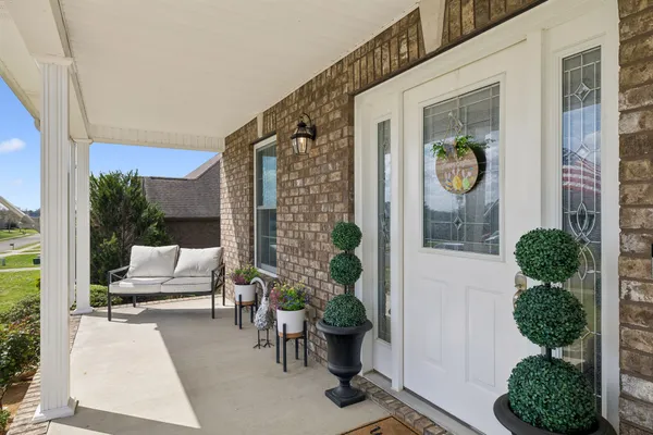 a building outdoor space with patio furniture and potted plants