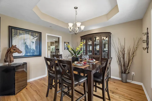 a view of a dining room with furniture wooden floor and chandelier