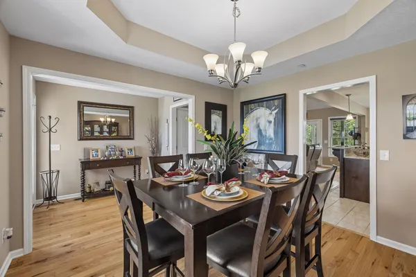 a view of a dining room with furniture wooden floor and chandelier
