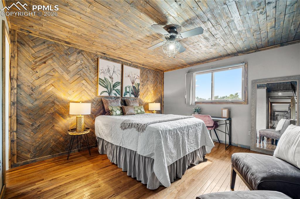 11 Mac Naughton Road Pueblo, CO 81001 - Photo 11 of 29 a bed room with a bed and a chandelier