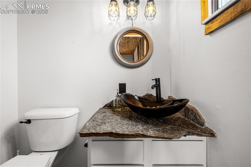 11 Mac Naughton Road Pueblo, CO 81001 - Photo 18 of 29 a bathroom with a granite countertop toilet and a sink