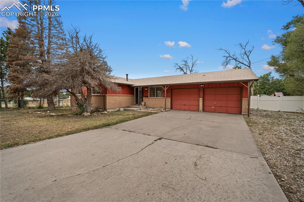 11 Mac Naughton Road Pueblo, CO 81001 - Photo 29 of 29 a front view of a house with a yard and garage