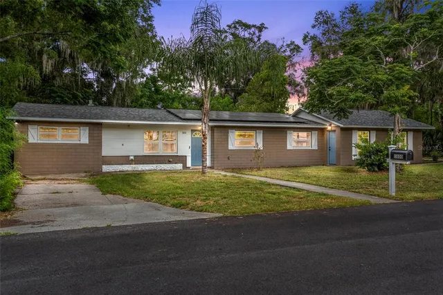 a view of a house with a backyard