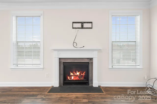 a living room with furniture a fireplace and a window