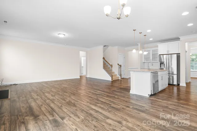 a view of a kitchen with furniture and wooden floor