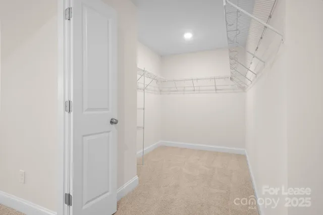 a spacious bathroom with a shower a mirror and a sink