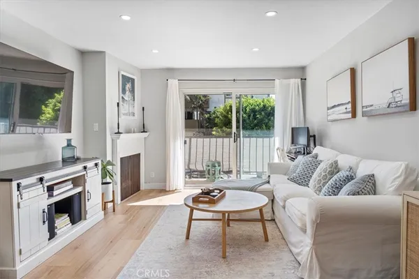 a living room with furniture a large window and a fireplace