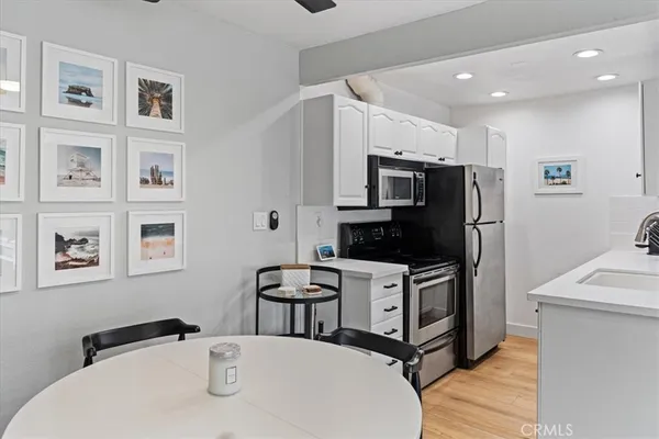 a view of a dining room with furniture and a kitchen view