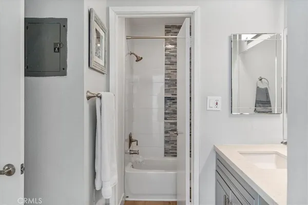 a bathroom with a sink and mirror with toilet