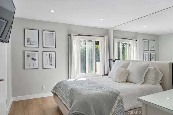 a bedroom with a large bed and a window