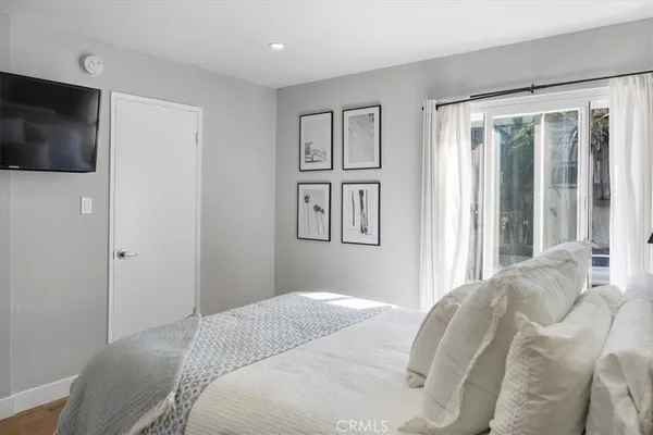 a bedroom with a bed a mirror and a table