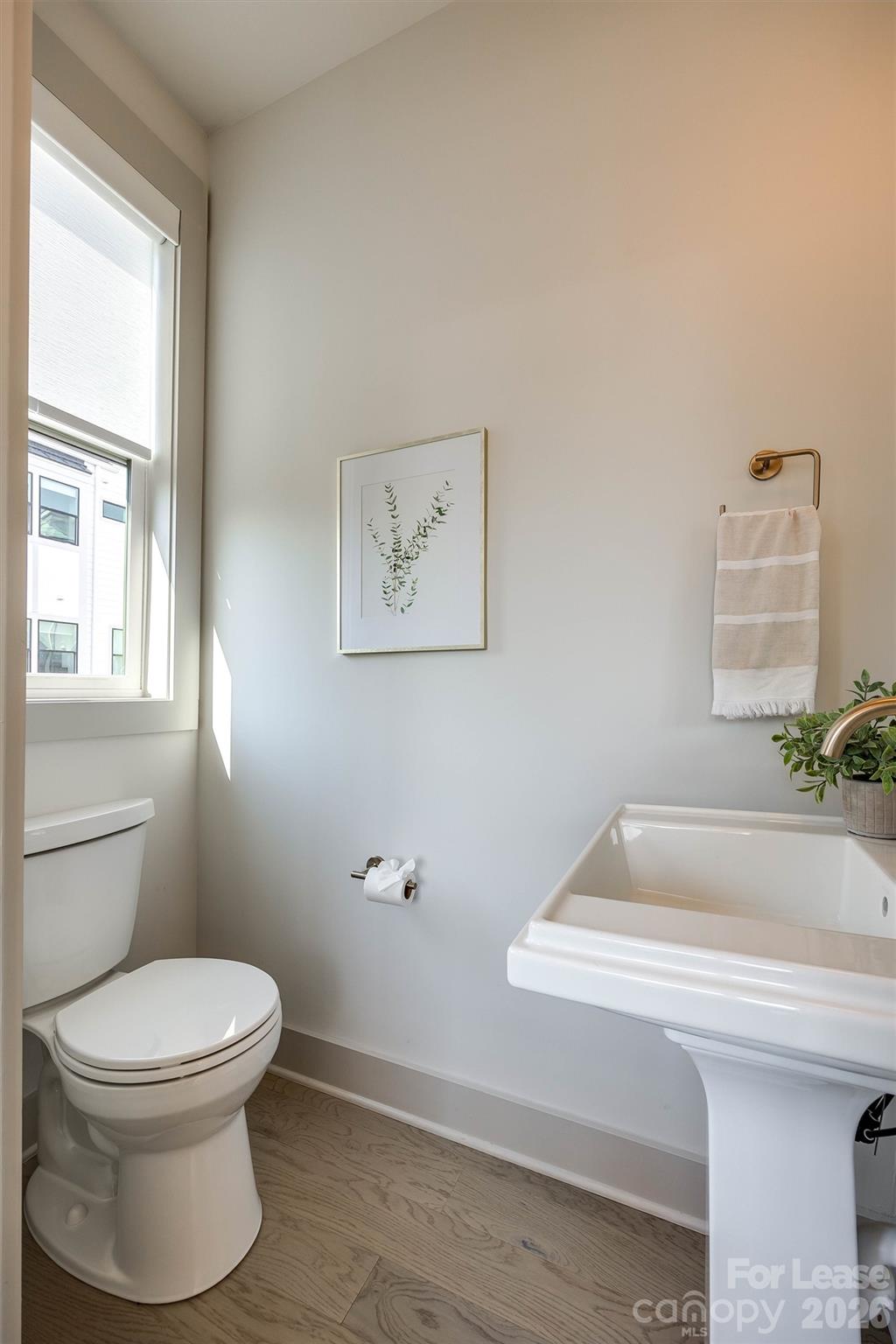 2319 Wesley Village Road Charlotte, NC 28208 - Photo 13 of 44 a bathroom with a toilet and a sink