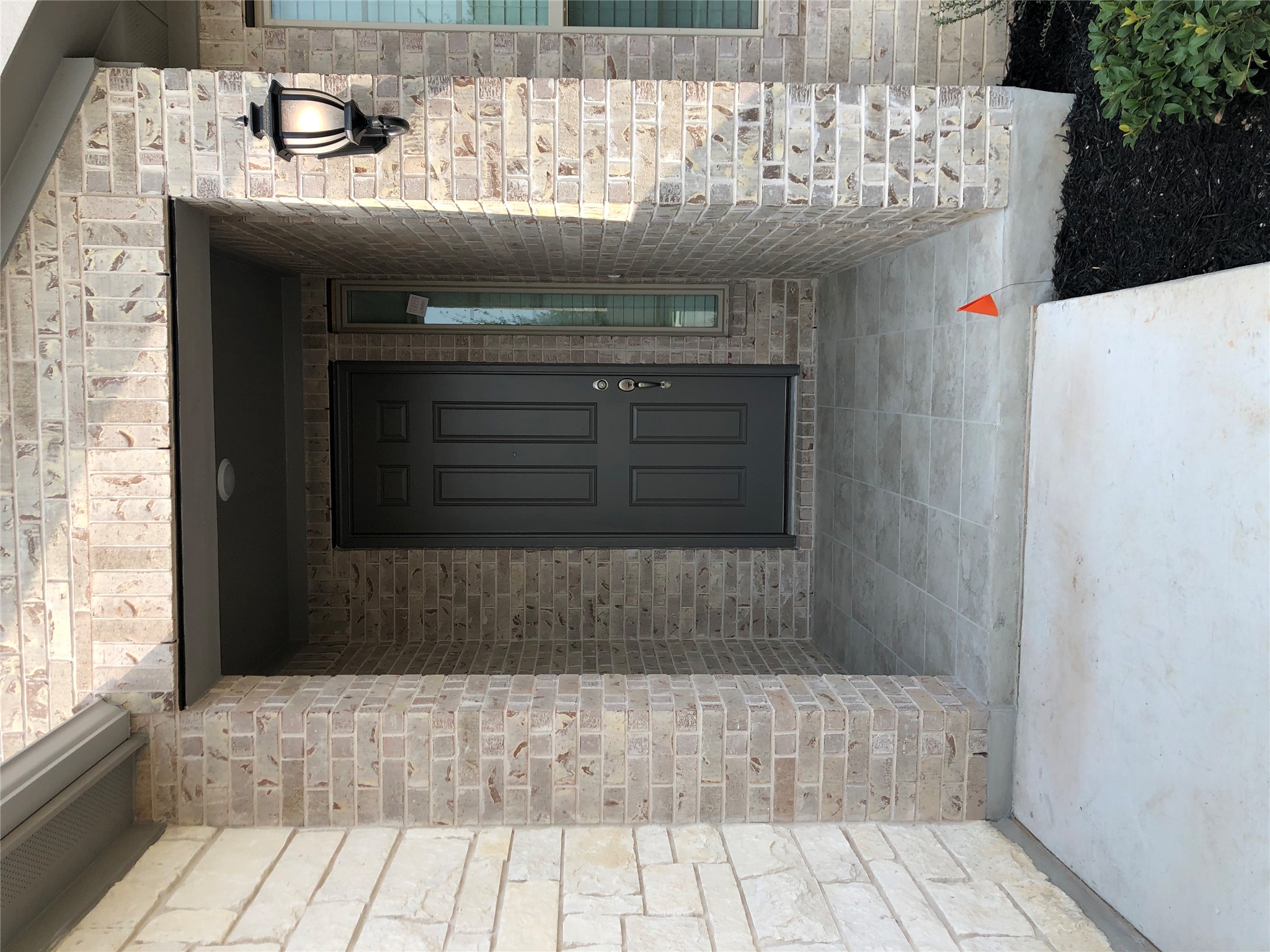 2746 Fortezza Way Round Rock, TX 78665 - Photo 2 of 16 A tiled alcove entry framed by classic brick and stone masonry offers a welcoming arrival.