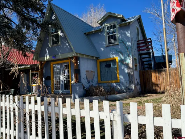a view of a house with wooden fence