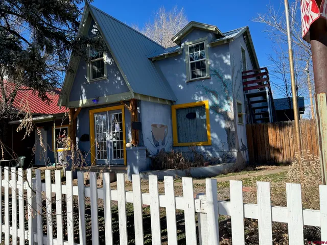 a view of a house with wooden fence