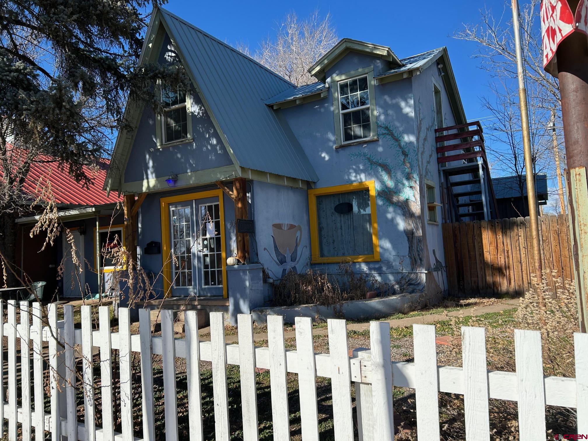 a view of a house with wooden fence