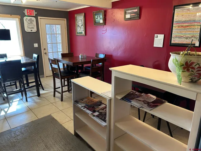 a kitchen with a table chairs and wooden floor