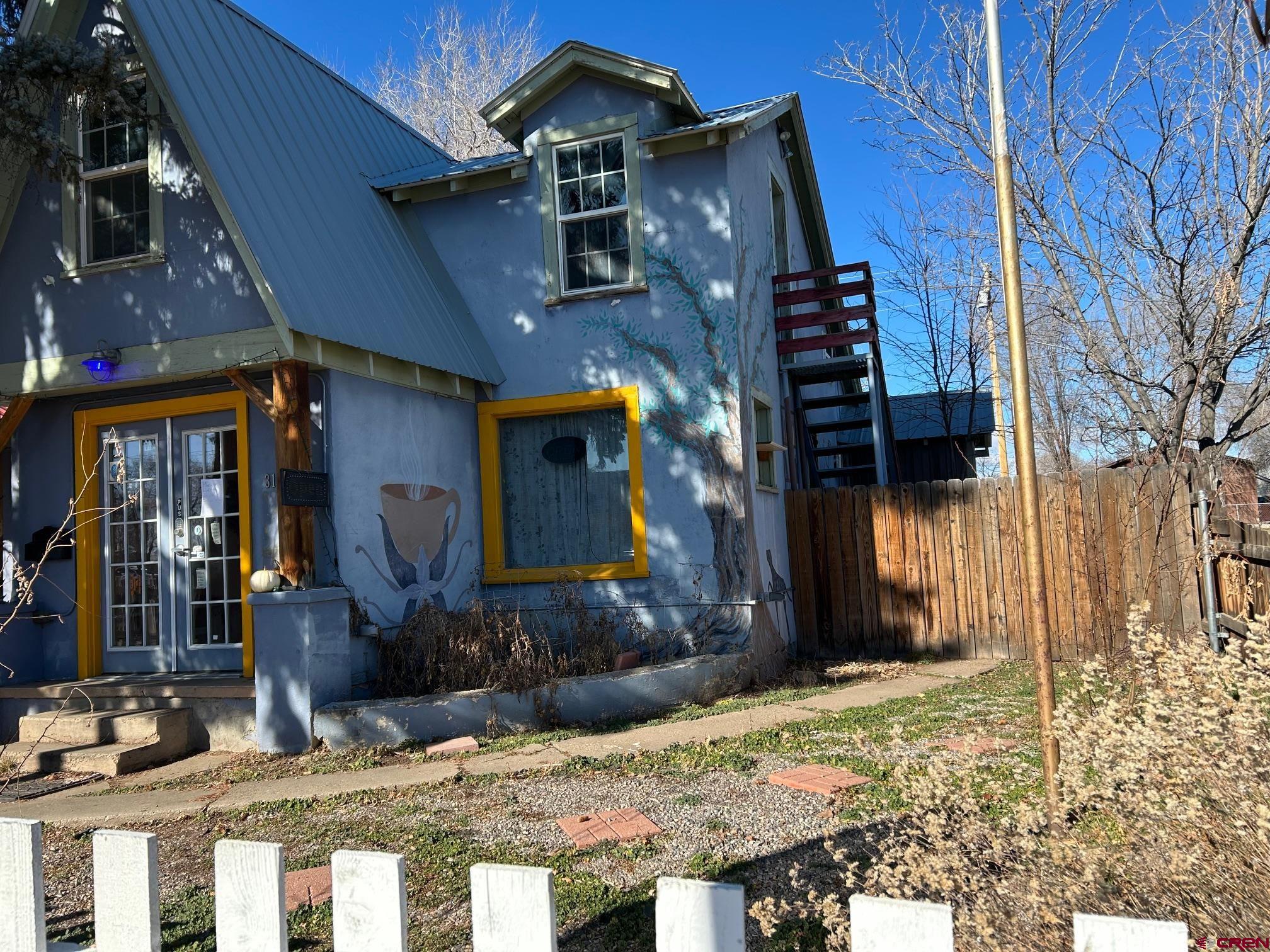 318 East Main Street Cortez, CO 81321 - Photo 25 of 27 a view of a house with a yard