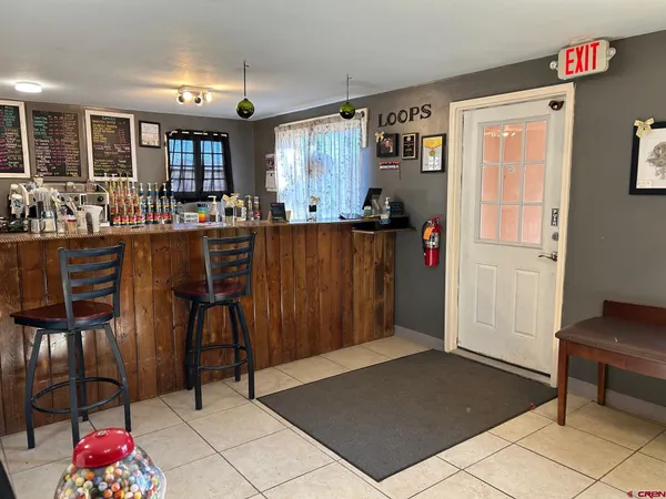 a open kitchen with granite countertop a refrigerator and a sink