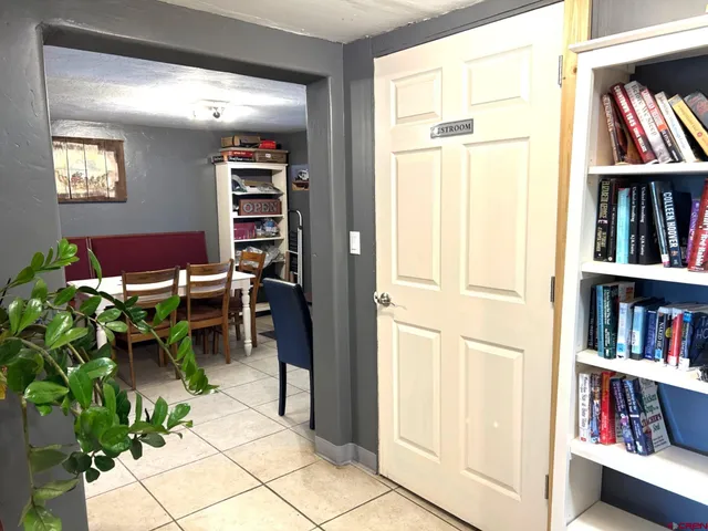 a view of living room with furniture and book shelf