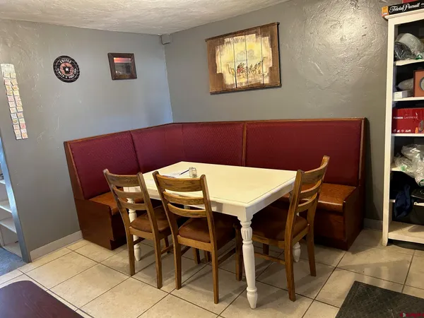 a view of a dining room with furniture and chandelier