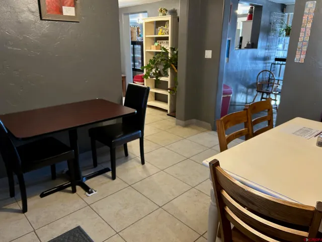 a view of a room with furniture and wooden floor