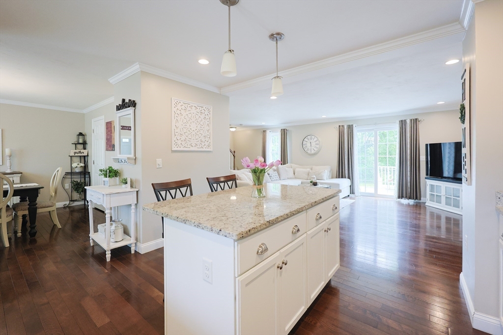 5 Mendon Road, Unit D Attleboro, MA 02703 - Photo 13 of 38 a hall with kitchen island hardwood floor and a view of living room