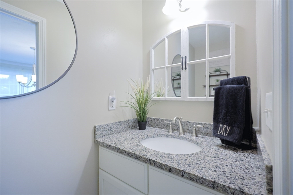 5 Mendon Road, Unit D Attleboro, MA 02703 - Photo 16 of 38 a bathroom with a granite countertop sink and a mirror
