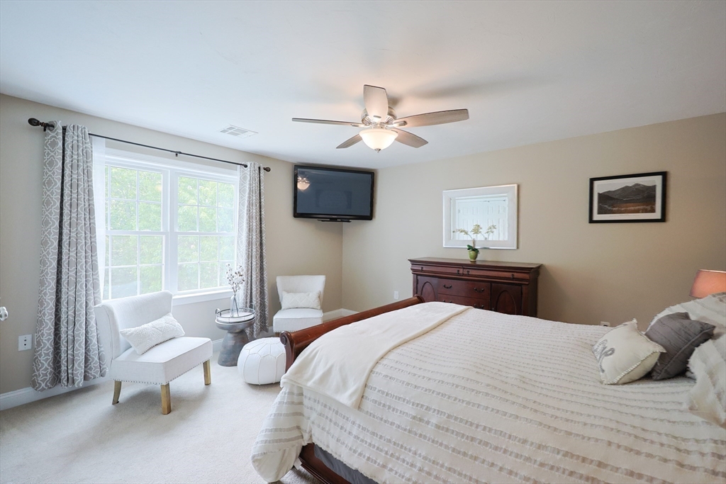 5 Mendon Road, Unit D Attleboro, MA 02703 - Photo 18 of 38 a bedroom with a bed and a chandelier