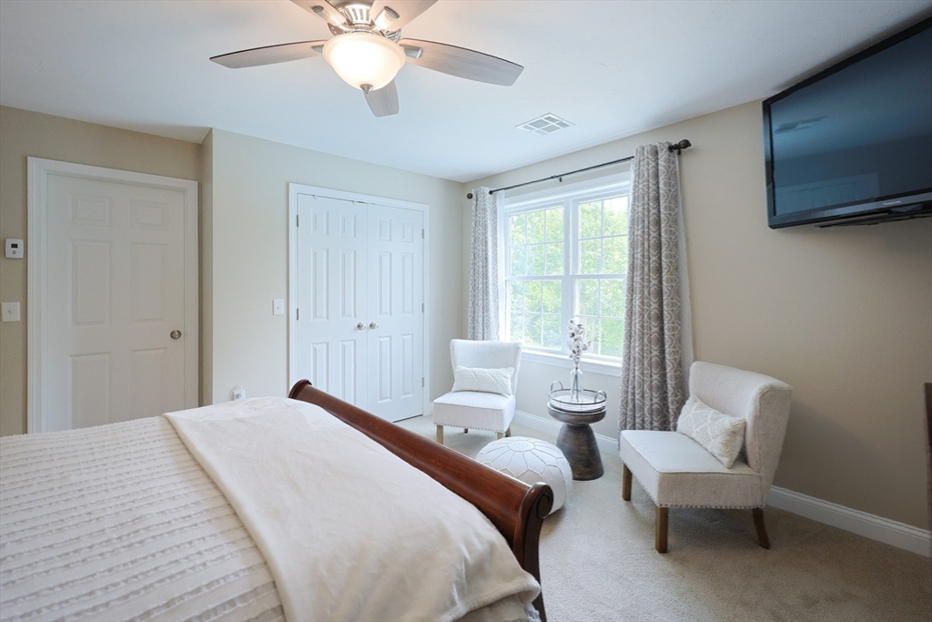 5 Mendon Road, Unit D Attleboro, MA 02703 - Photo 20 of 38 a bedroom with a bed and a chandelier