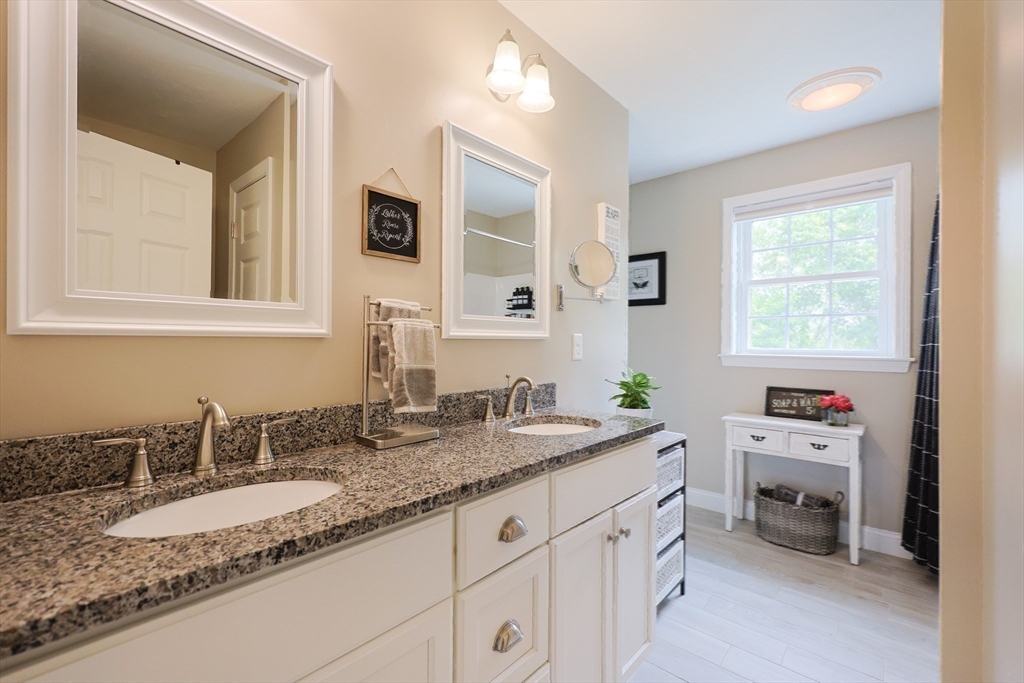 5 Mendon Road, Unit D Attleboro, MA 02703 - Photo 22 of 38 a bathroom with a granite countertop sink mirror and window