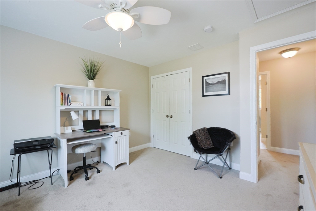 5 Mendon Road, Unit D Attleboro, MA 02703 - Photo 29 of 38 a workspace with furniture and a chandelier