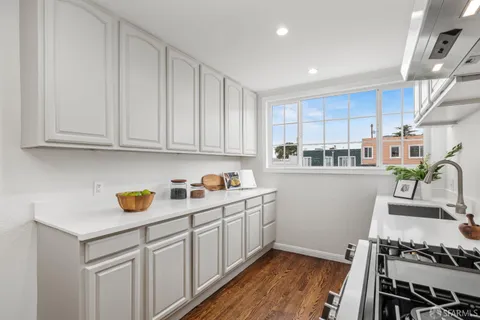 a kitchen with stainless steel appliances granite countertop a stove a sink and a microwave