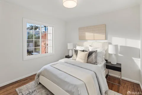 a kitchen with a sink cabinets and wooden floor