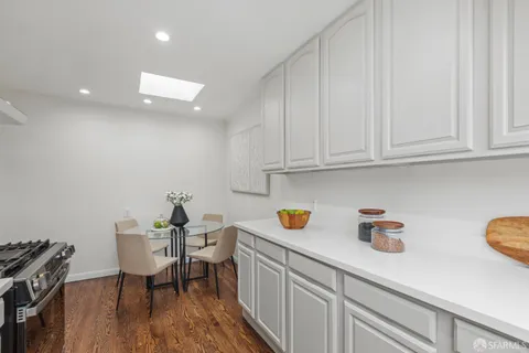 a kitchen with a sink cabinets and wooden floor