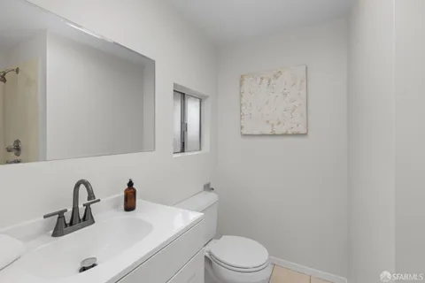 a bedroom with a bed and a painting on the wall