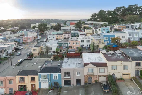 a backyard of a house with barbeque oven table and chairs