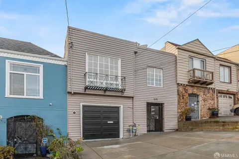 a view of a hallway with bathroom and wooden floor