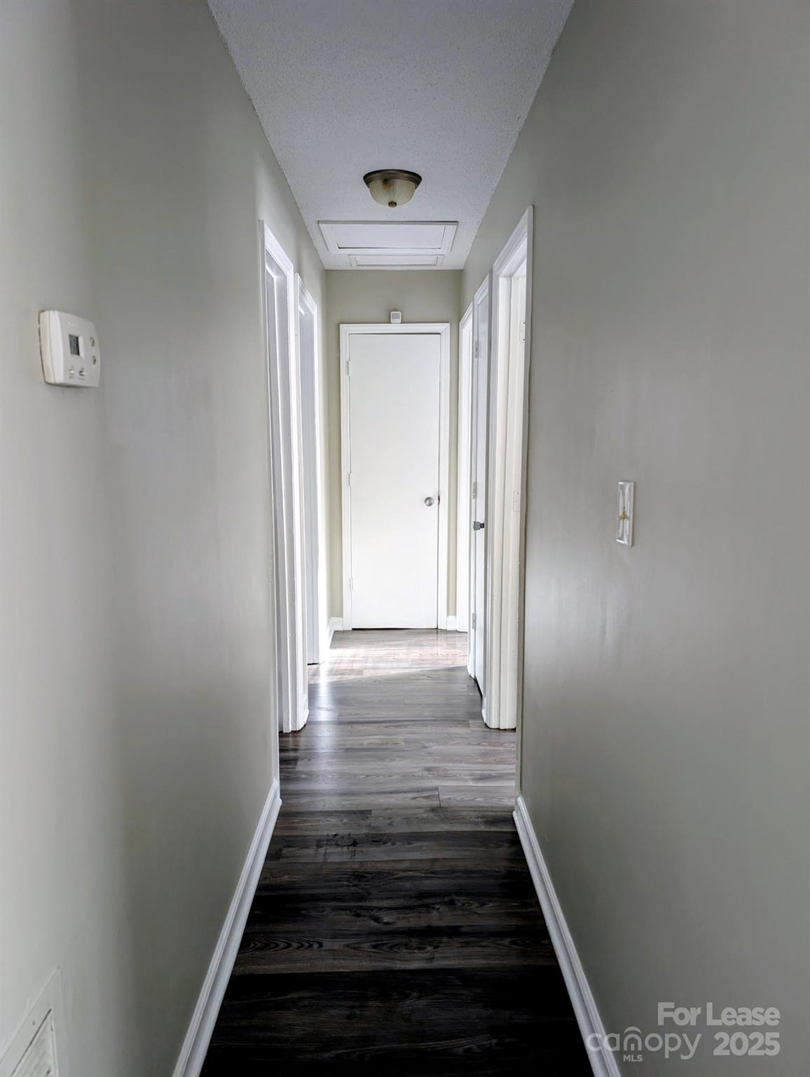 216 Lakeside Avenue Davidson, NC 28036 - Photo 7 of 10 a view of a hallway with wooden floor and staircase