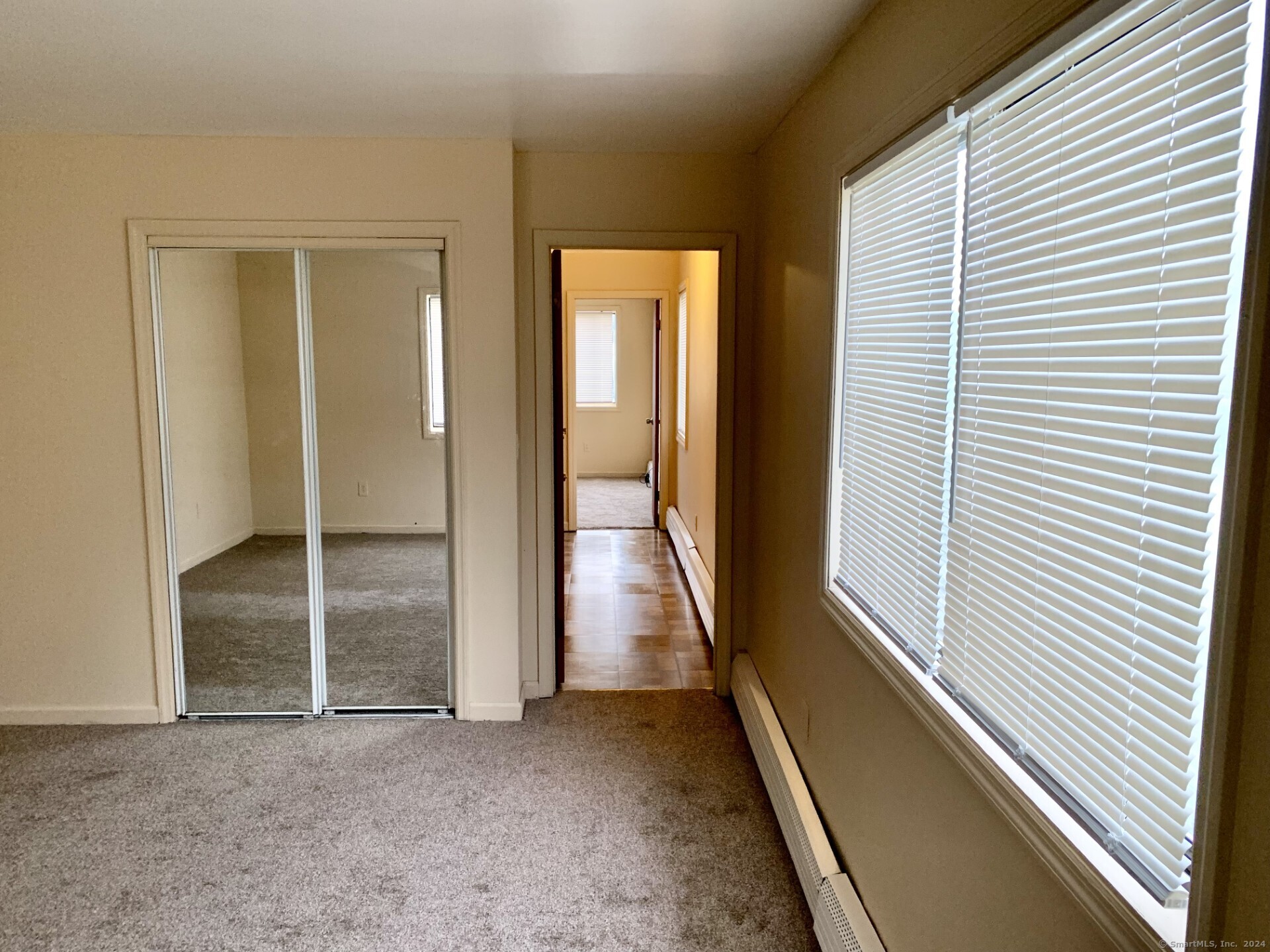 1380 Kossuth Street Bridgeport, CT 06608 - Photo 13 of 22 a view of a room with wooden floor and windows