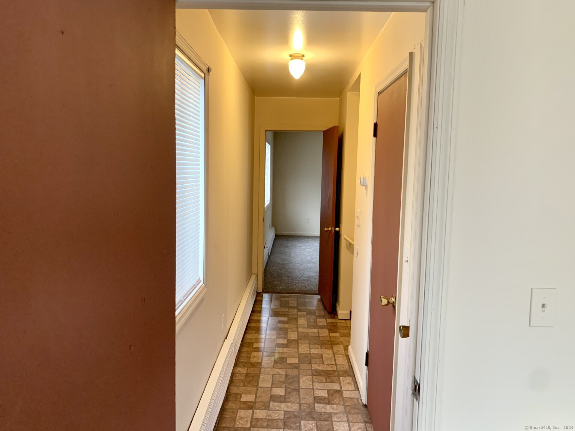 1380 Kossuth Street Bridgeport, CT 06608 - Photo 15 of 22 a view of a hallway with wooden floor