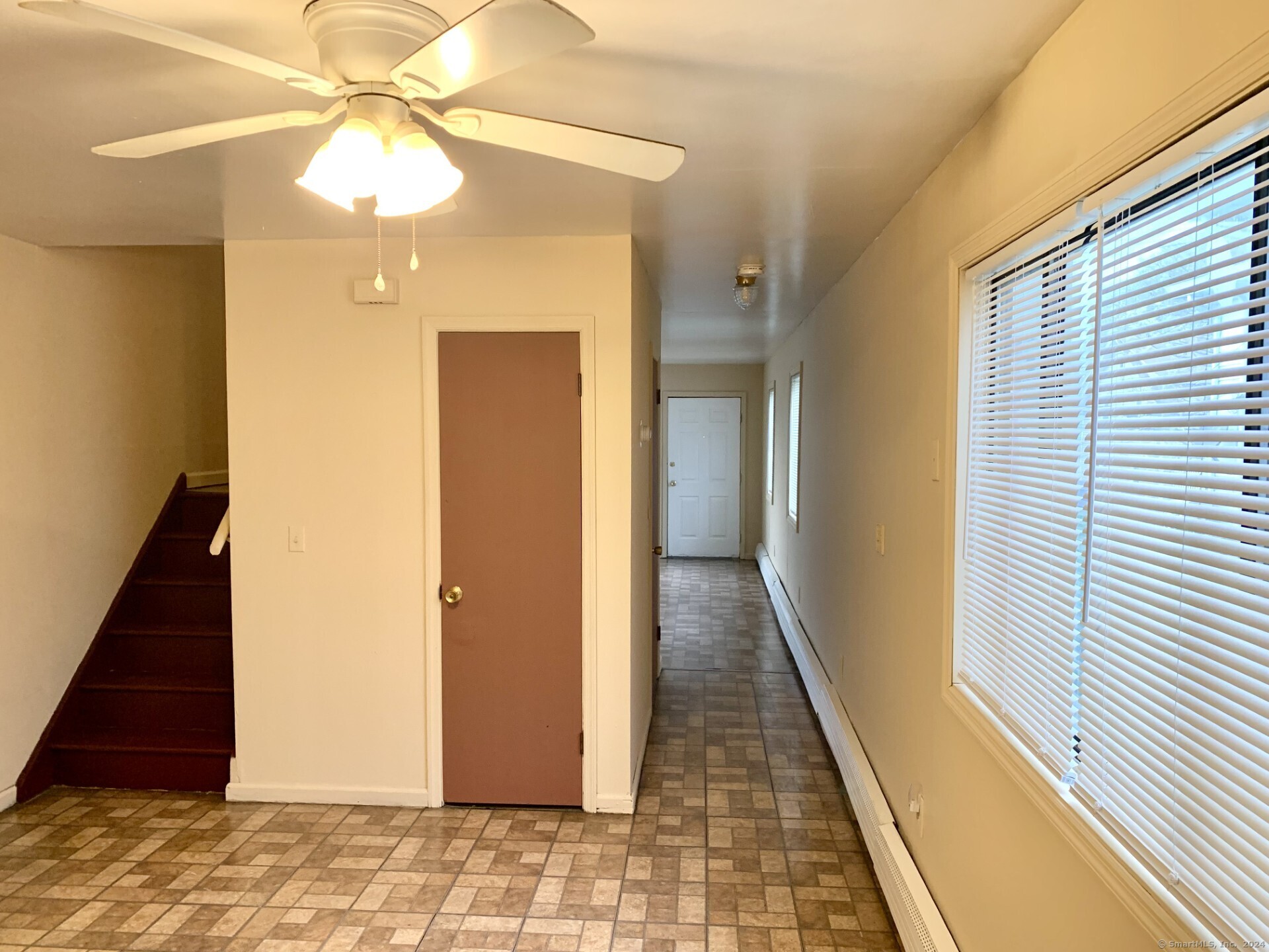 1380 Kossuth Street Bridgeport, CT 06608 - Photo 9 of 22 a view of a hallway with wooden floor and staircase